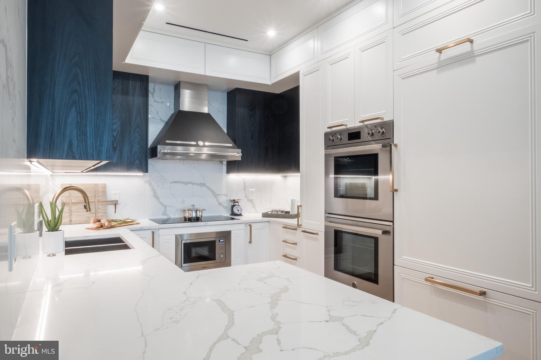 a kitchen with granite countertop a stove and a sink