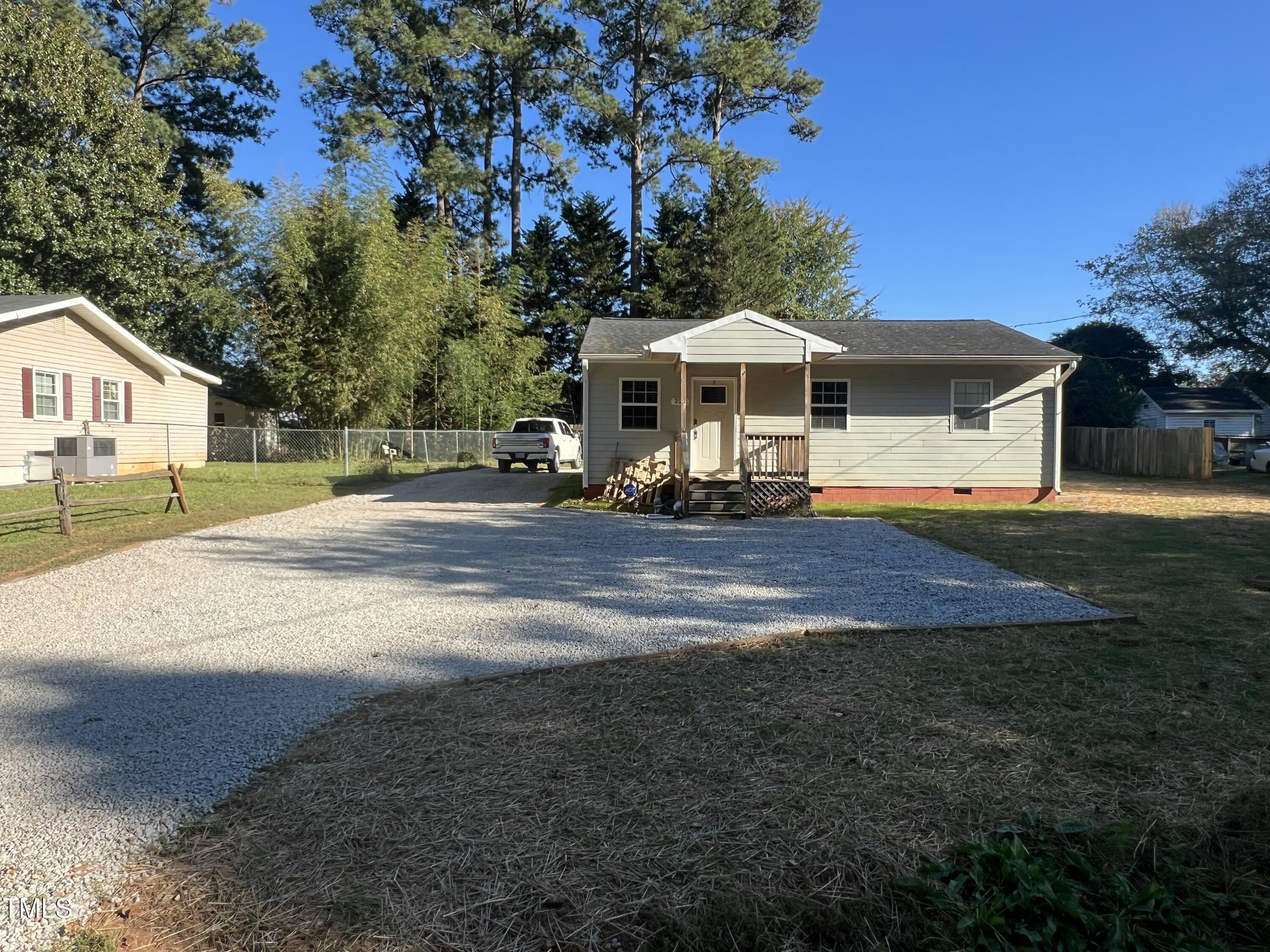 a front view of a house with yard and mountain view in back yard