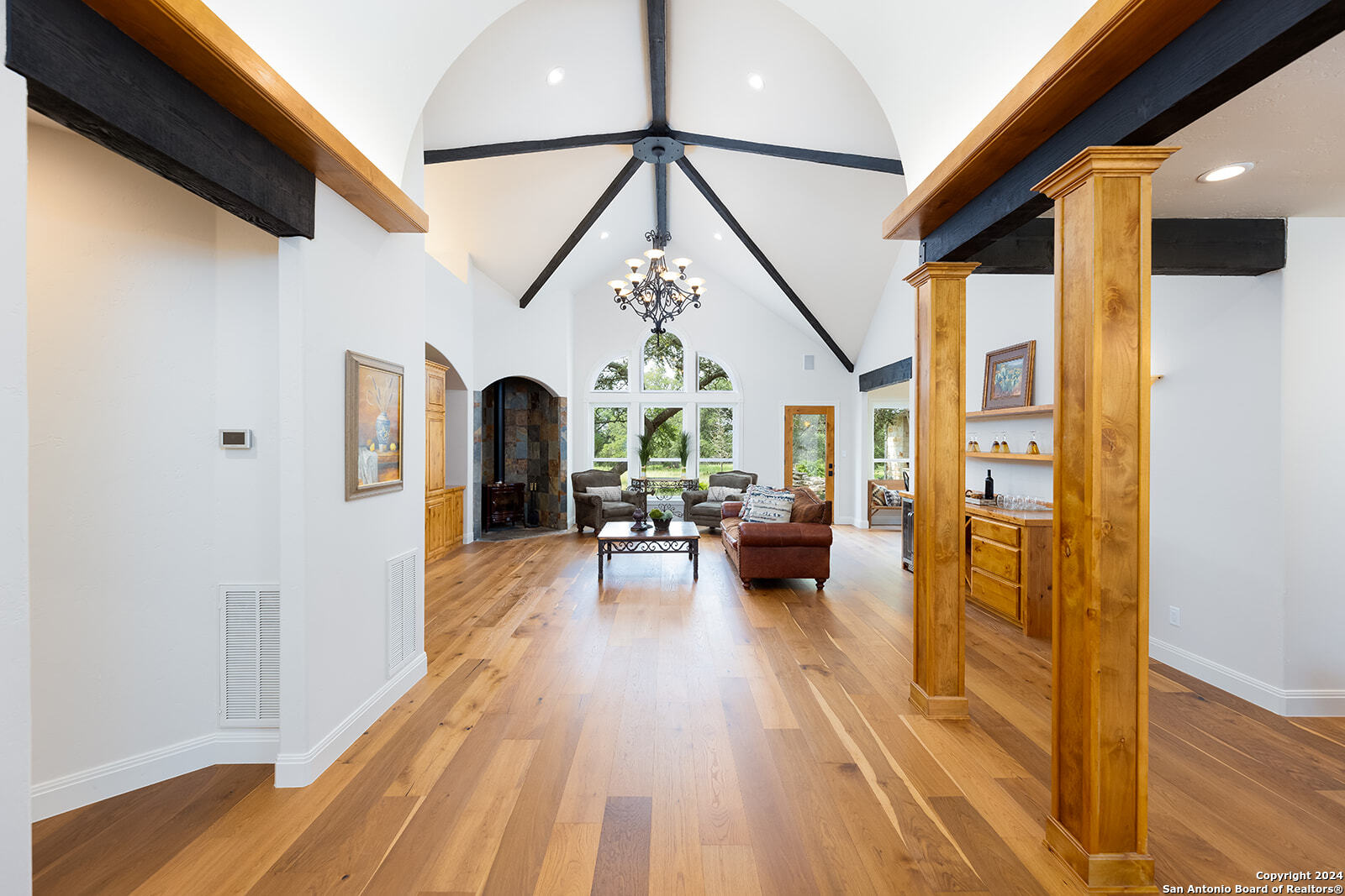 a view of living room with furniture and a fireplace