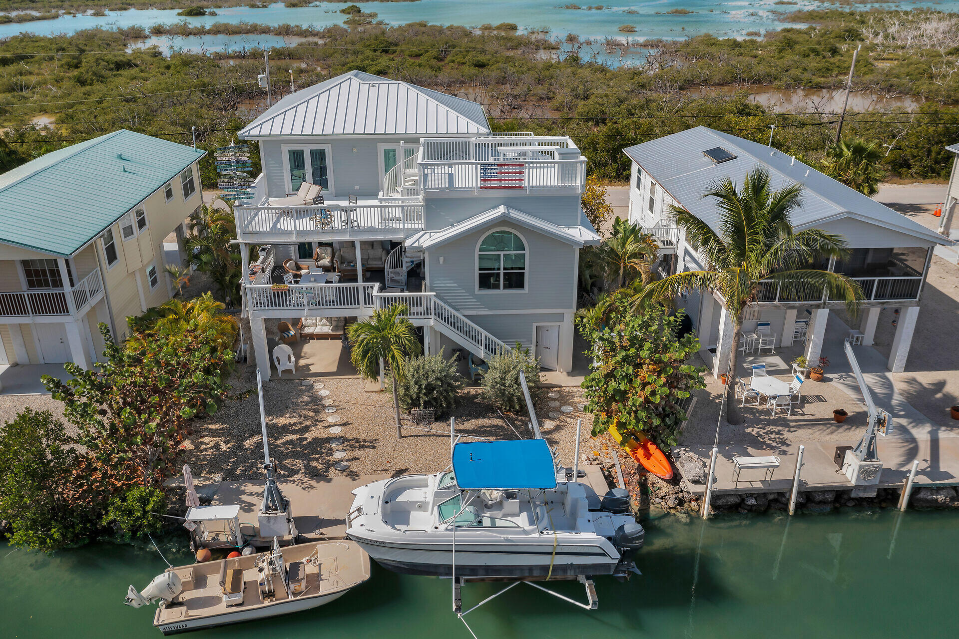 a aerial view of a house with swimming pool and a yard