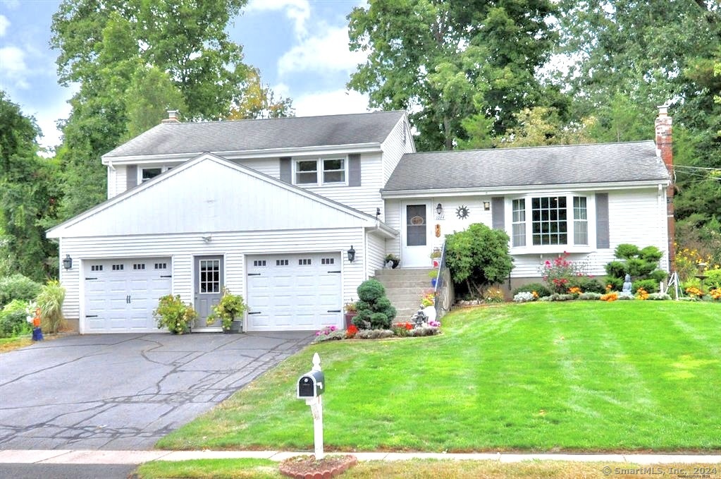 a front view of a house with garden