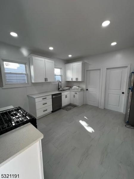 a kitchen with a sink a stove and refrigerator