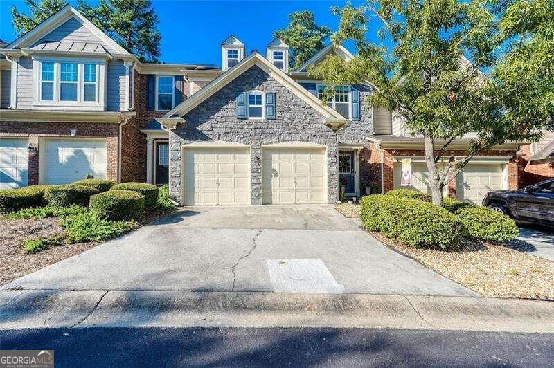 a front view of a house with a yard and a garage