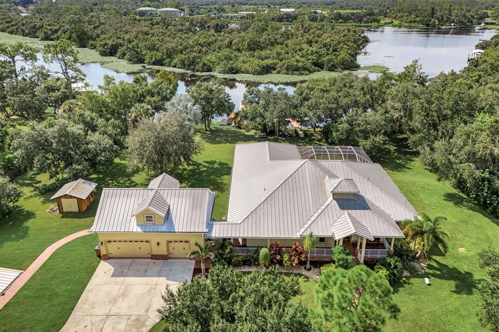 an aerial view of a house with outdoor space and lake view