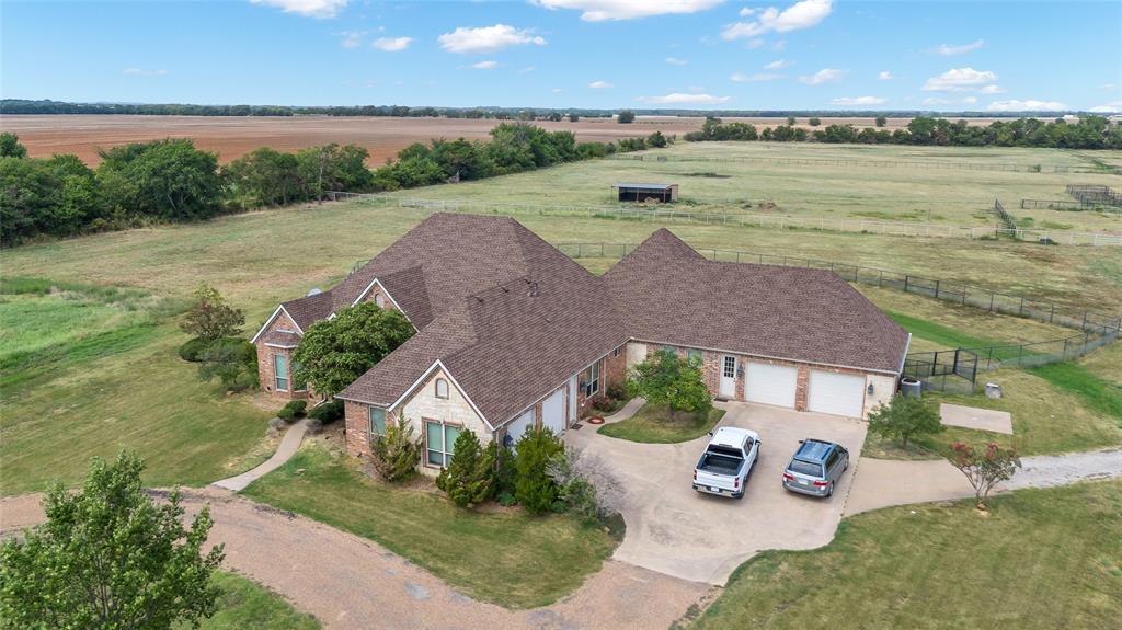 an aerial view of a house with garden space and ocean view