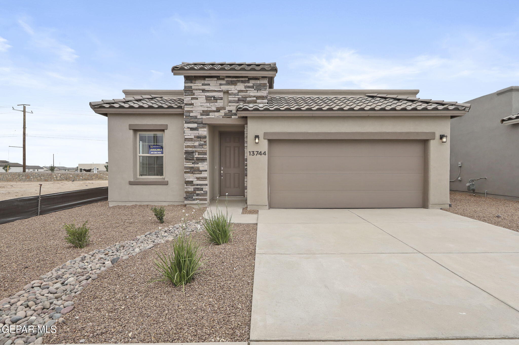 a front view of a house with parking space