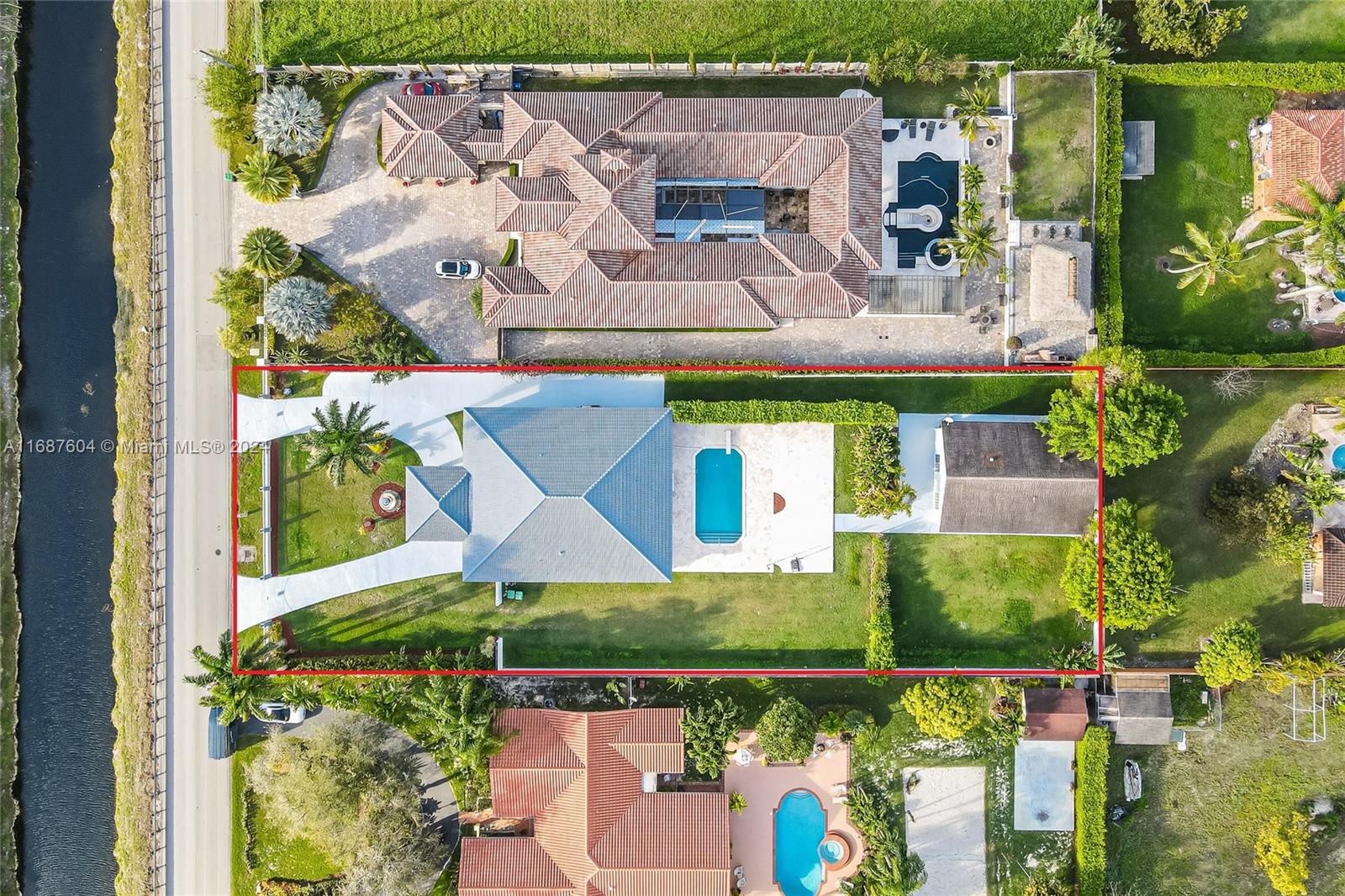 an aerial view of a house with a garden and trees