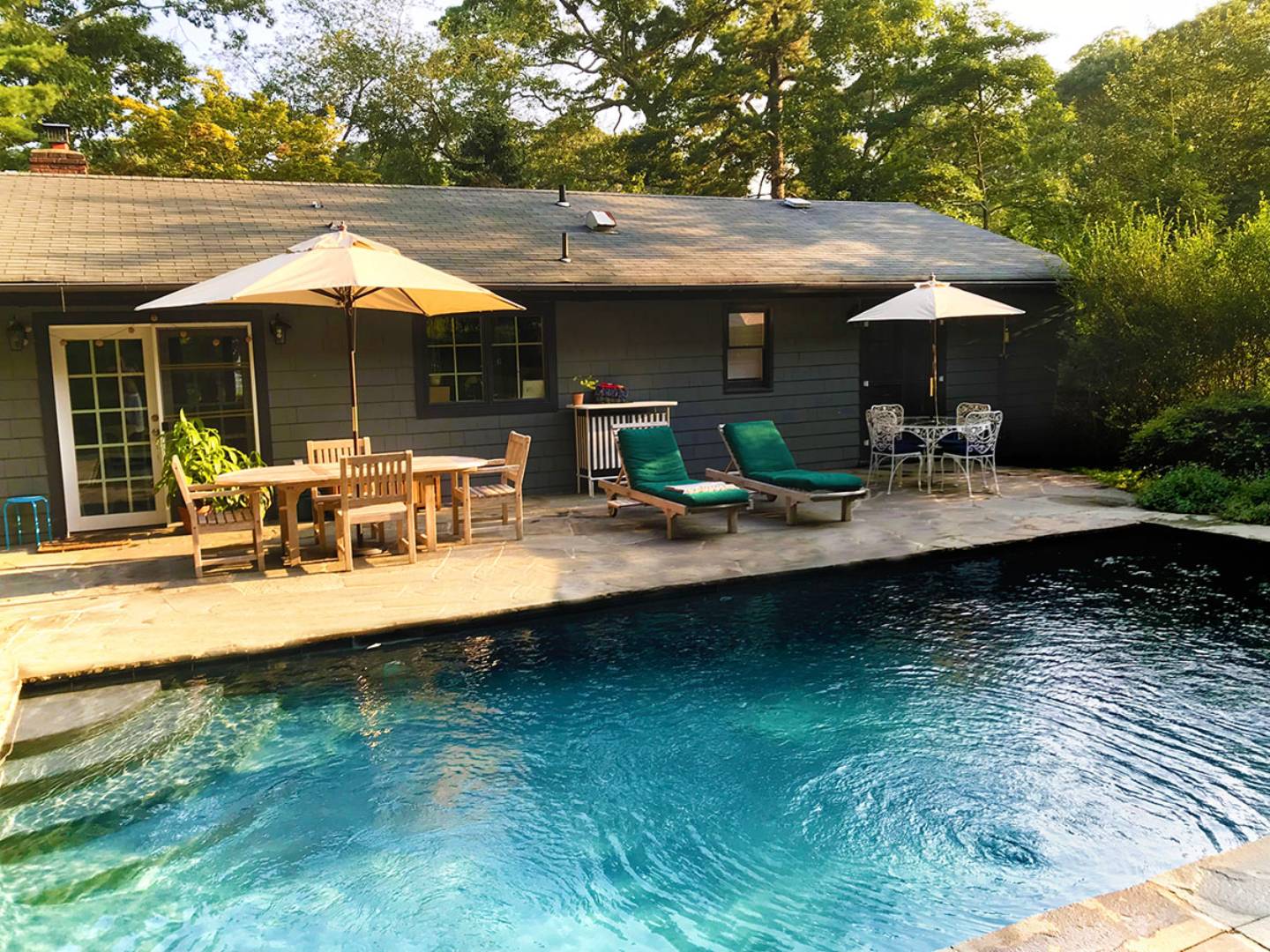 swimming pool view with a seating space