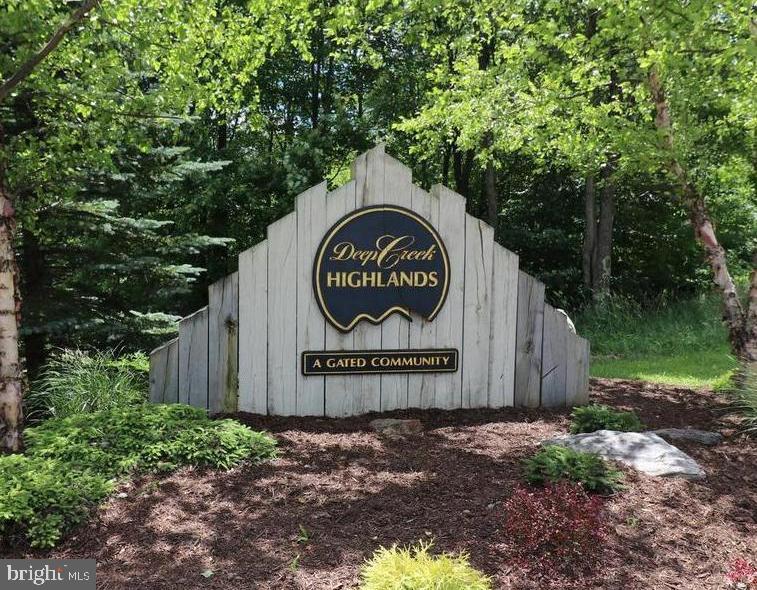 a view of a sign of a park next to a road