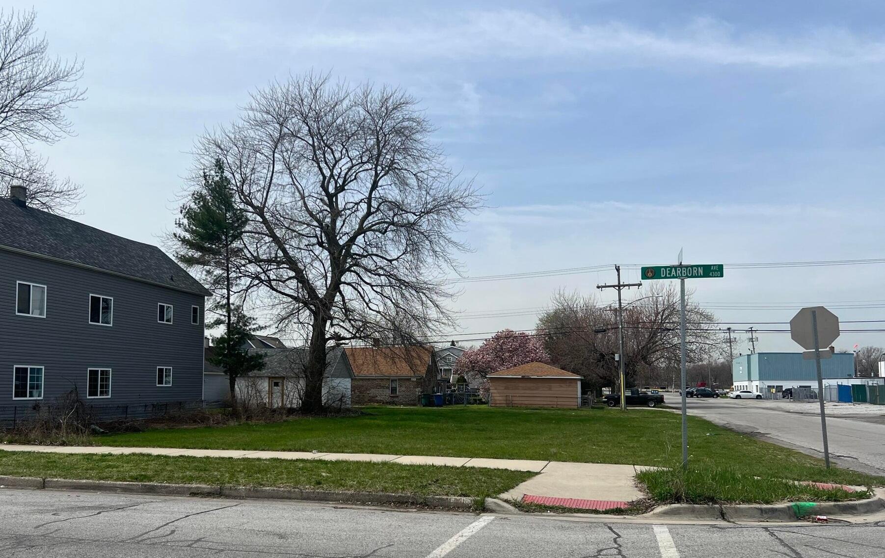 a front view of a house with a yard and a fountain