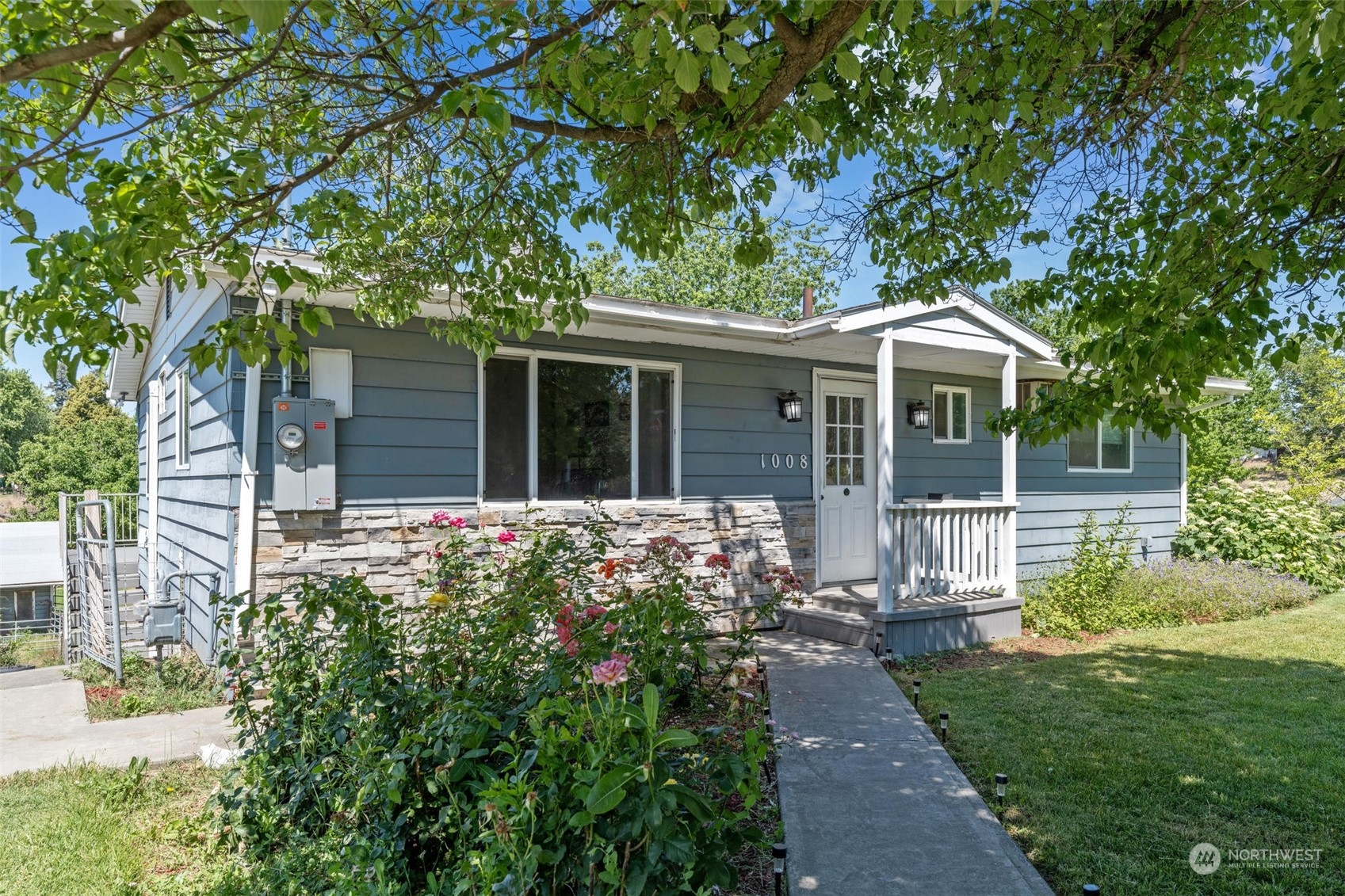 a front view of a house with garden