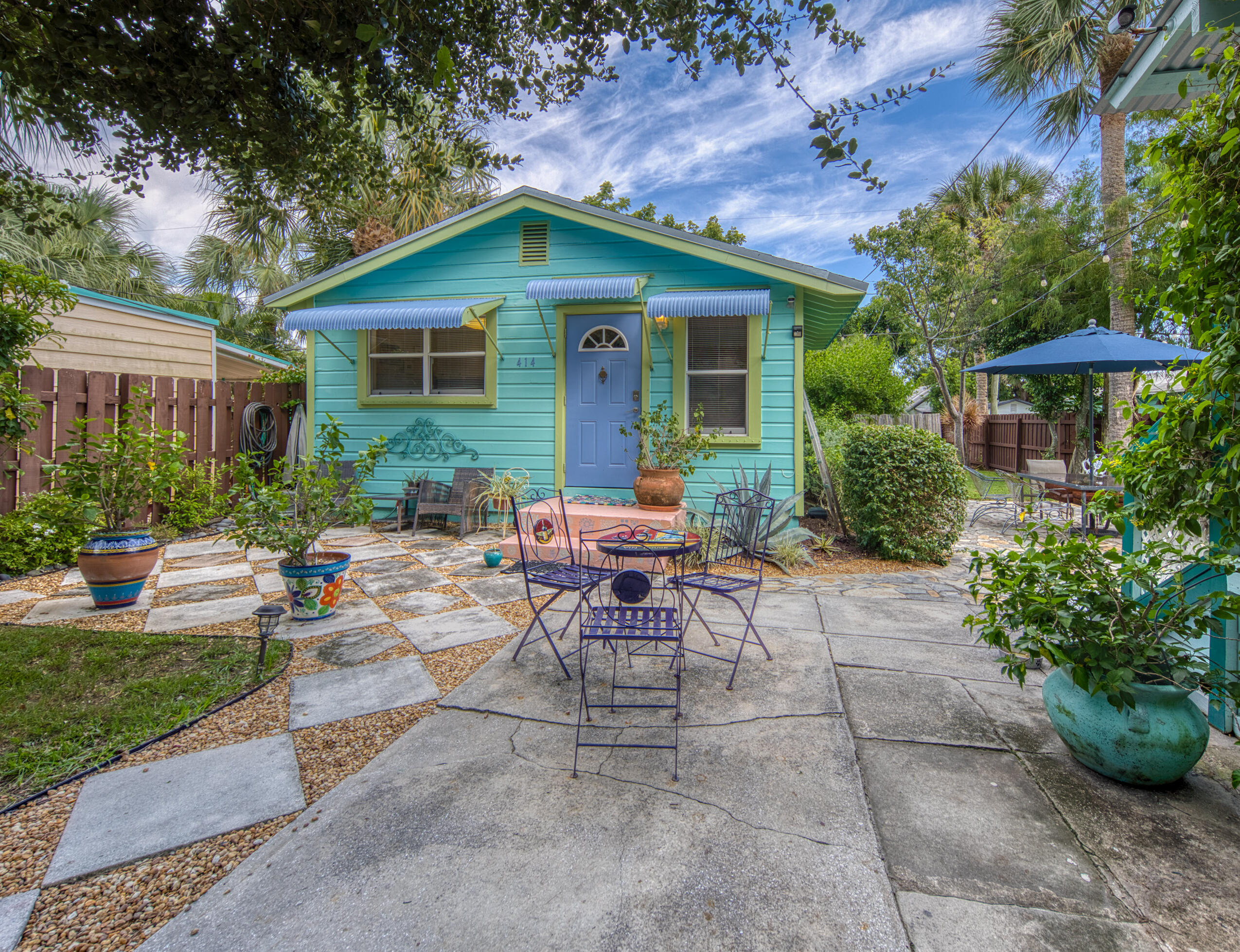 a view of a house with backyard sitting area and garden