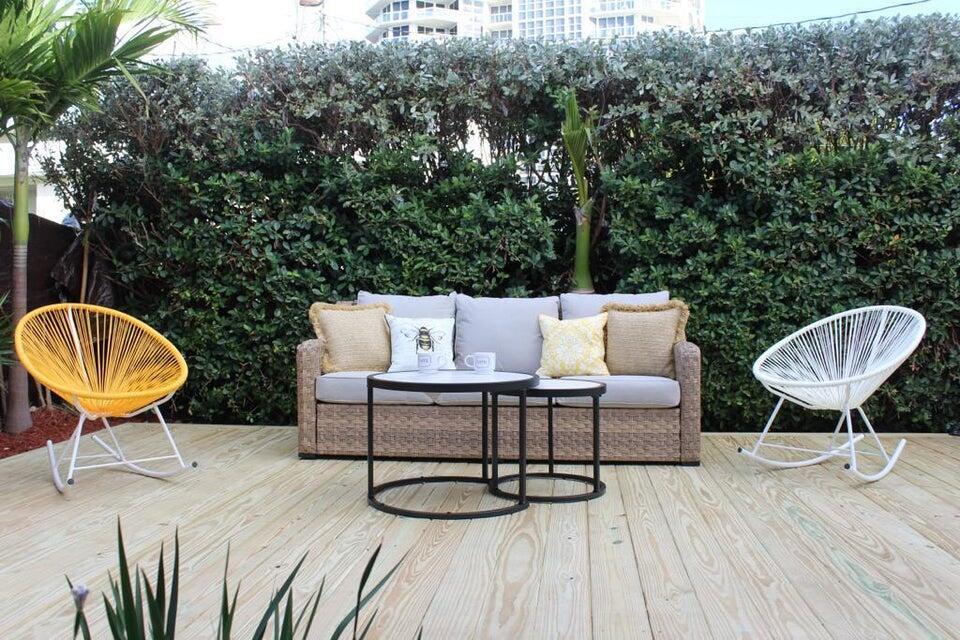 a view of a chairs and table in backyard