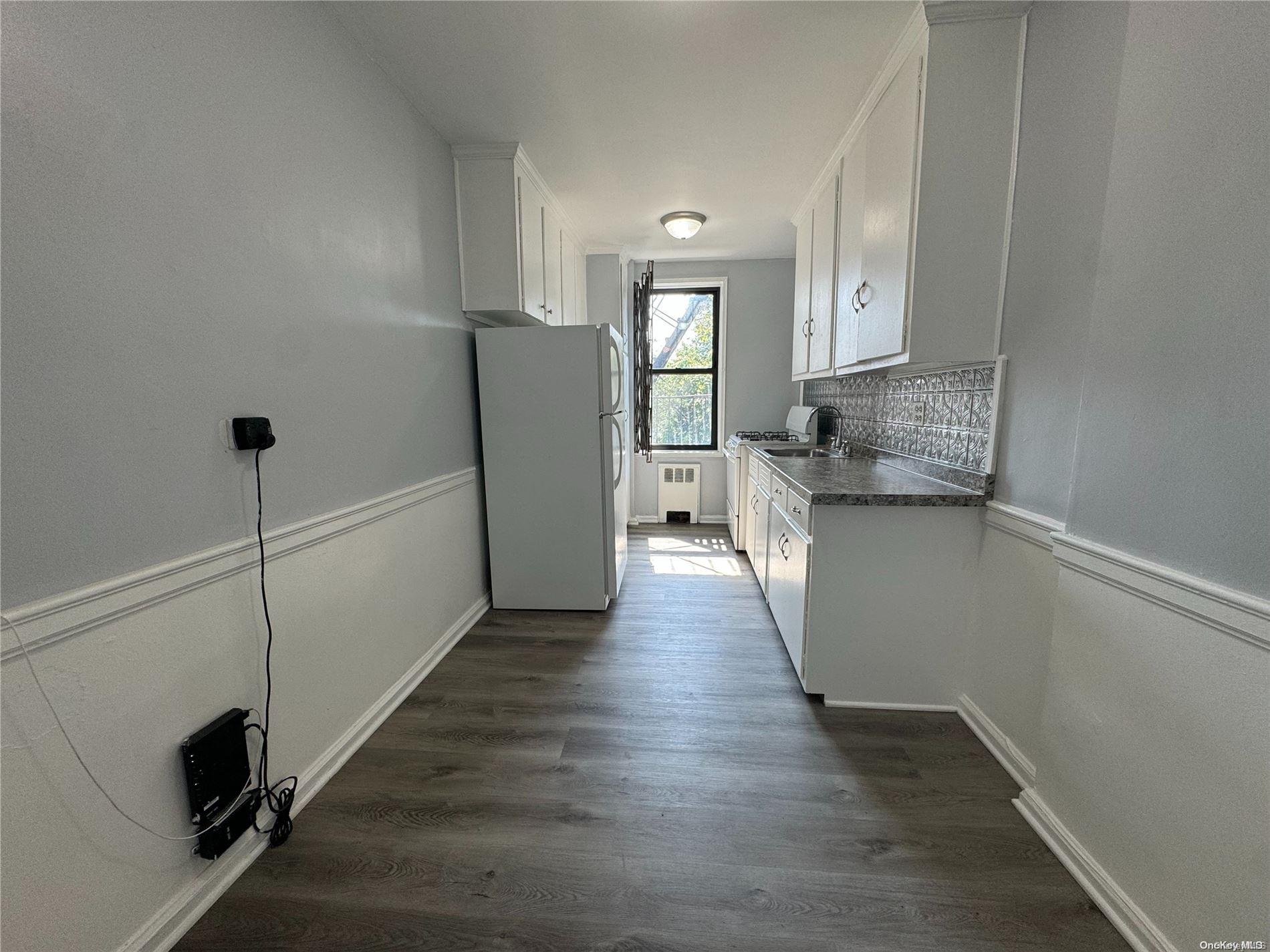 a view of a kitchen cabinets and wooden floor