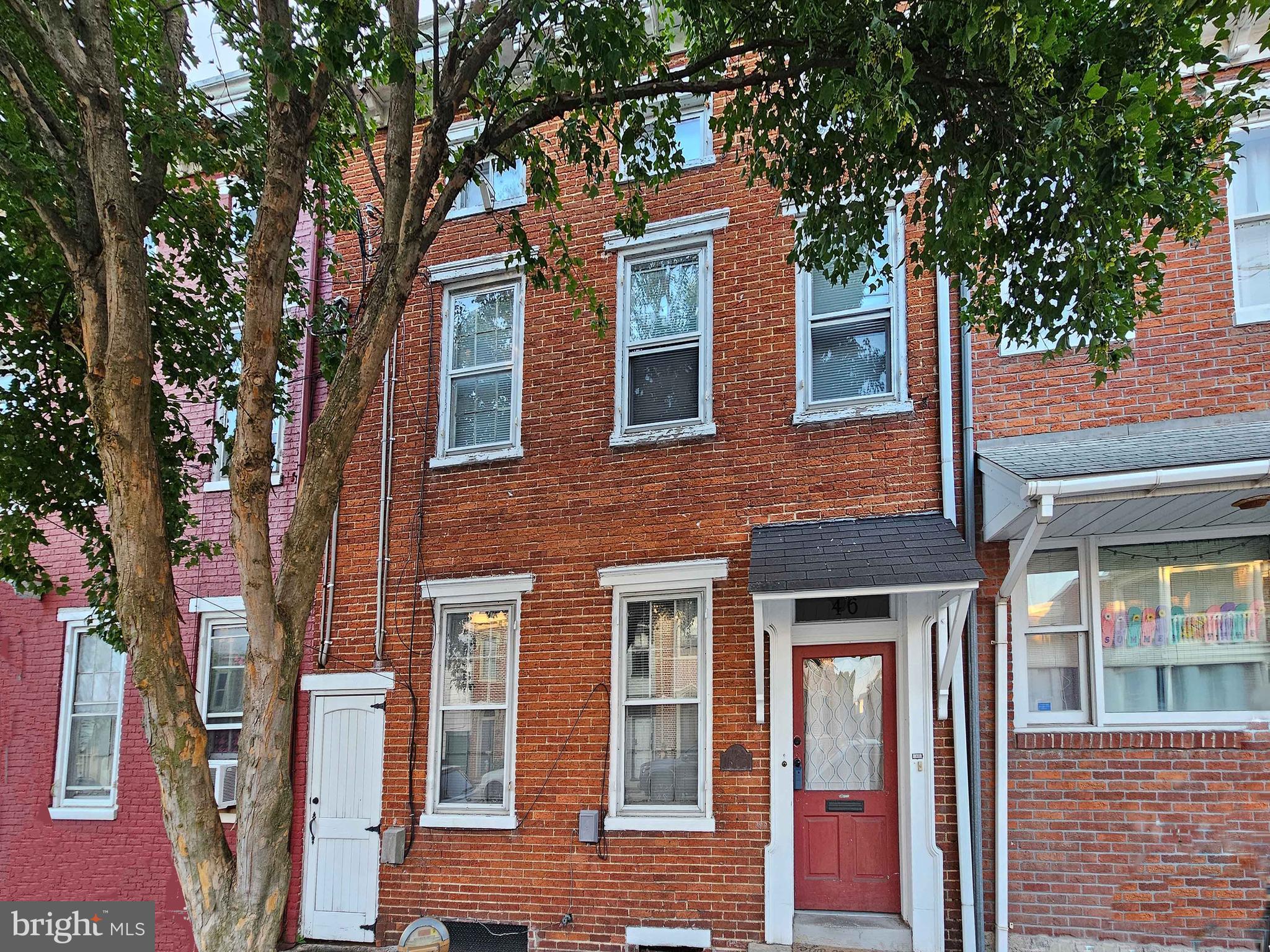 a front view of a brick house with large windows