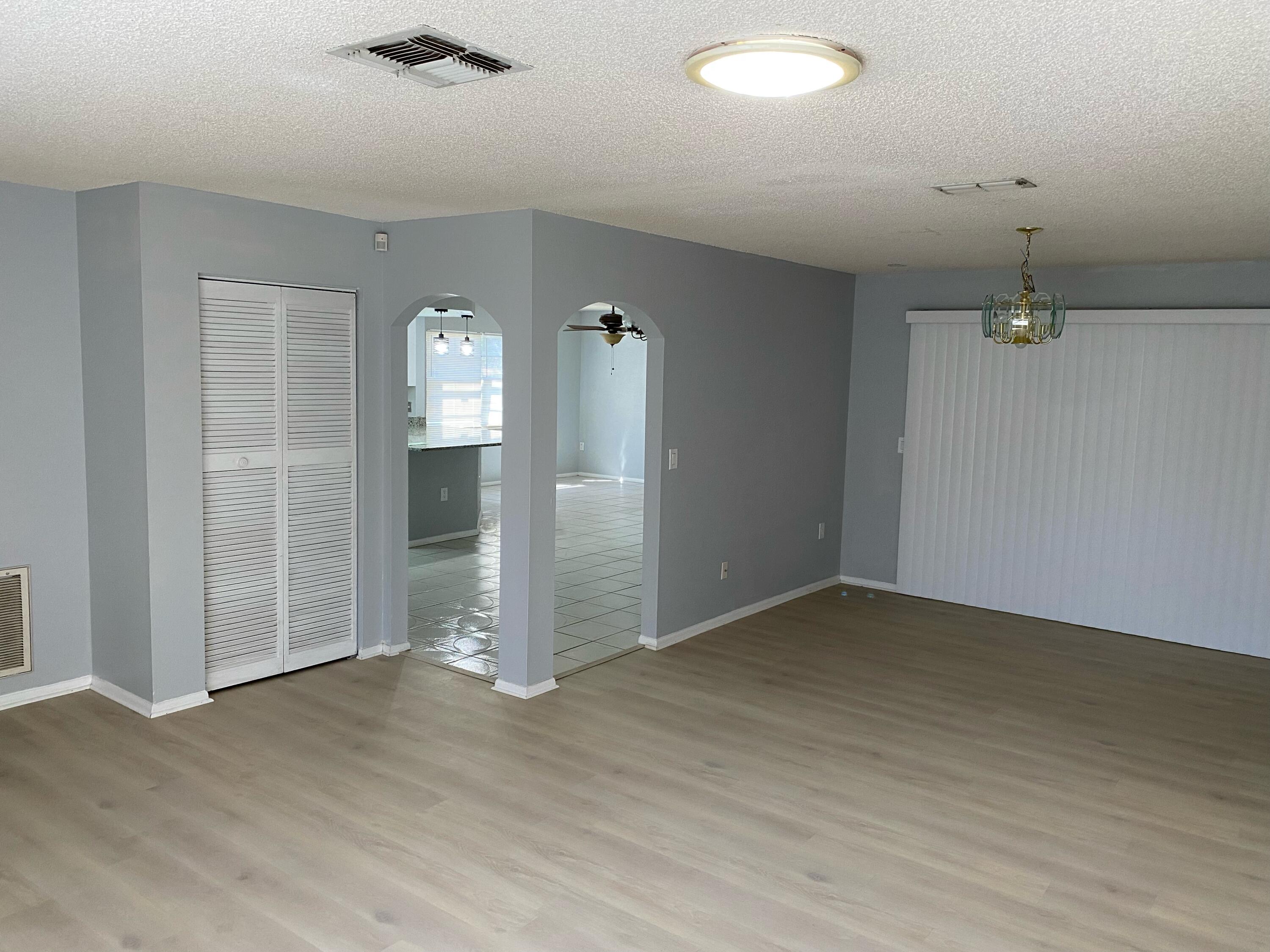 an empty room with closet and windows