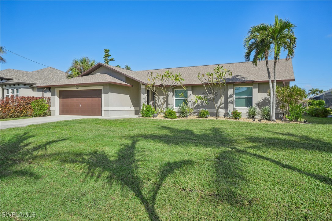 a front view of house with yard and green space