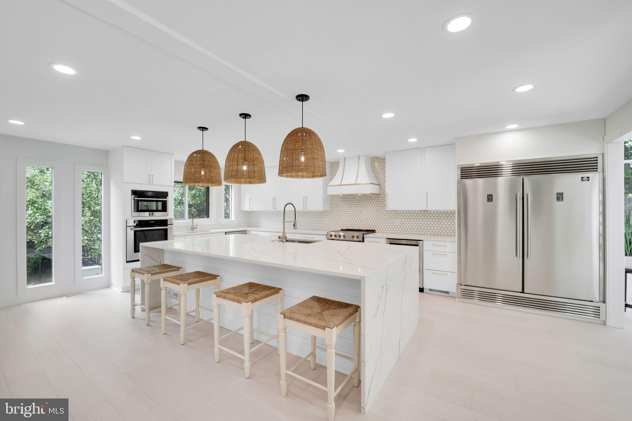 a kitchen with stainless steel appliances granite countertop a stove and a refrigerator