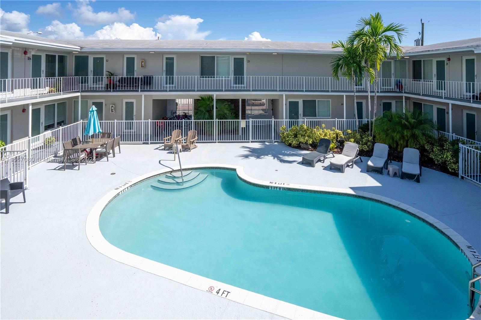 a view of a swimming pool with outdoor seating