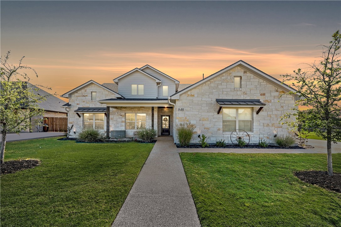 a front view of a house with a yard