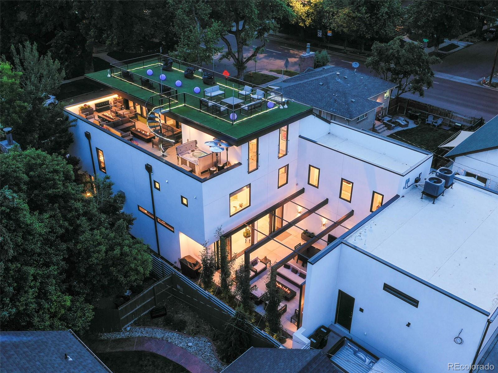 an aerial view of a house with a yard patio and outdoor seating