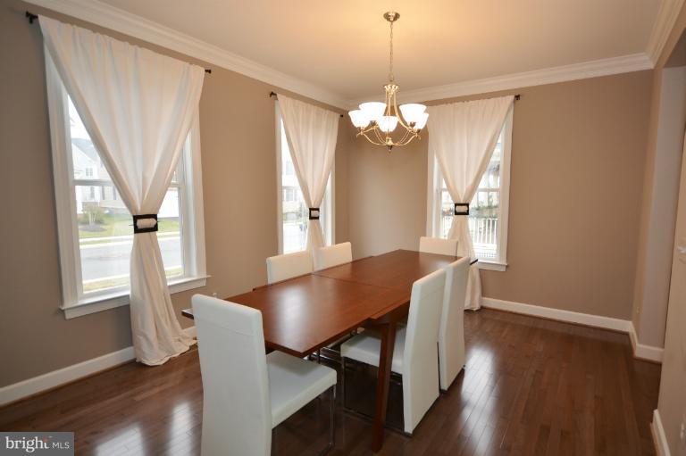 Dining Room feat. Crown Molding and Hardwood Floor