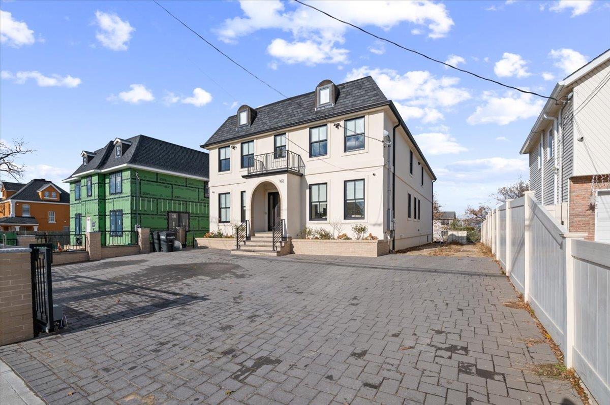 View of front of property with a balcony