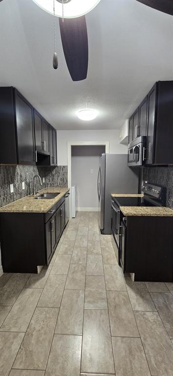 a kitchen with a stove a sink and a refrigerator