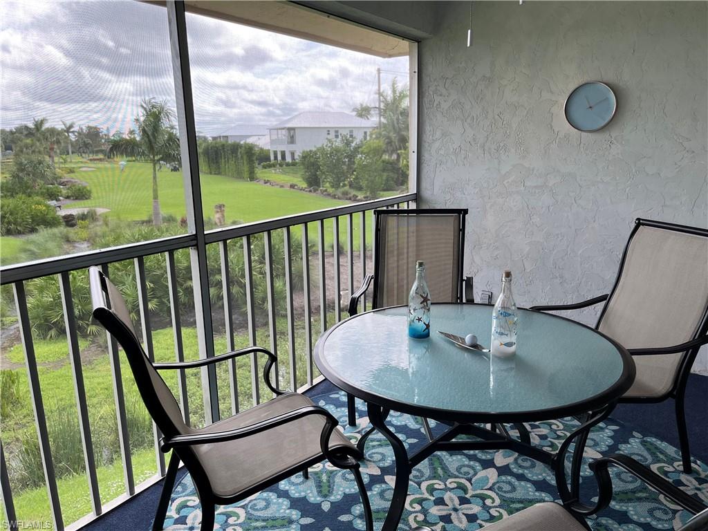 a view of a chairs and table in a balcony