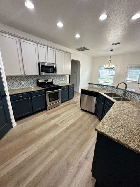 a large kitchen with stainless steel appliances granite countertop a stove a sink dishwasher and a refrigerator