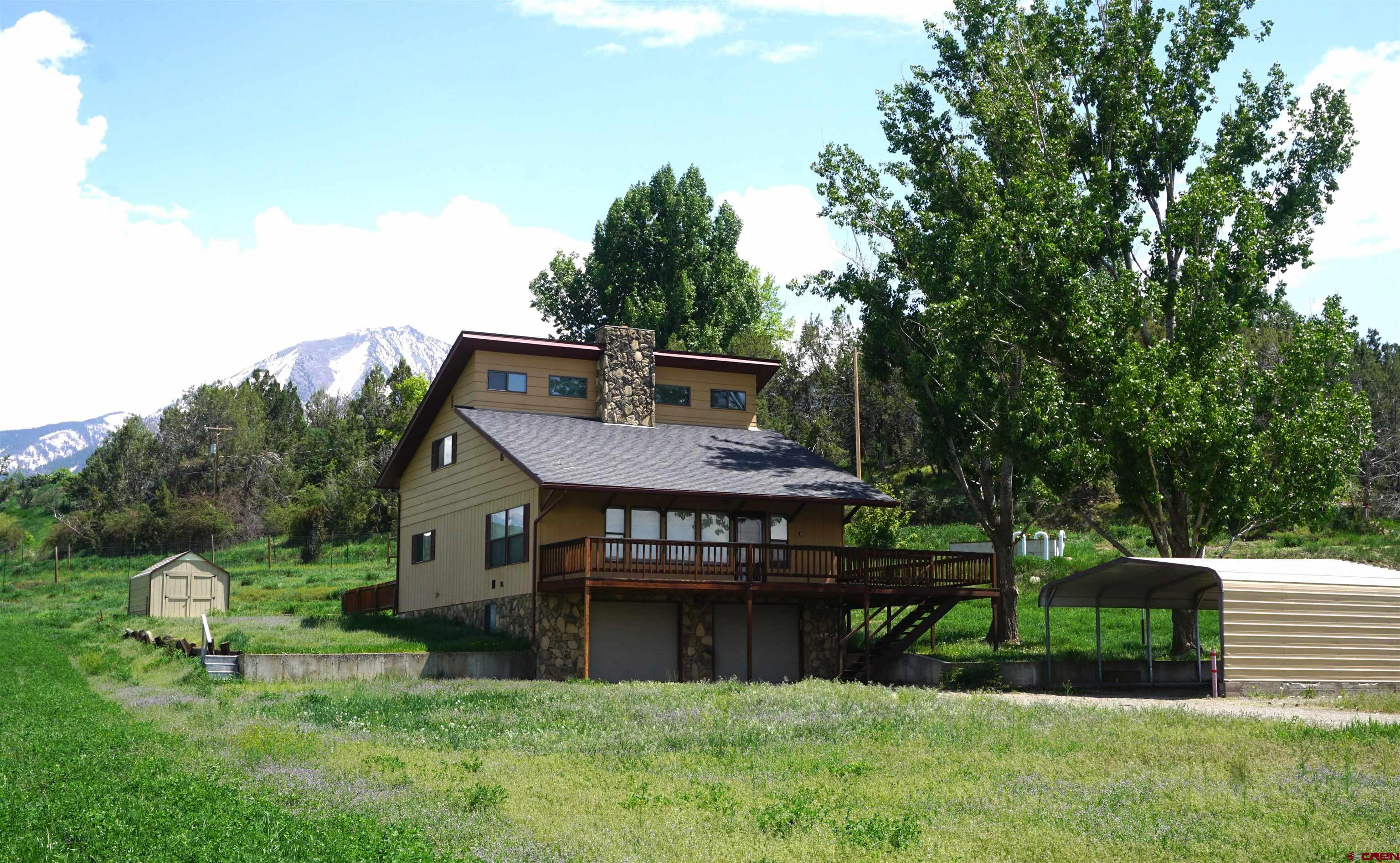 a view of a house with a backyard and a patio