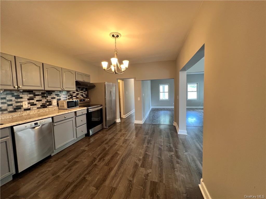 a open kitchen with cabinets a counter top space and stainless steel appliances