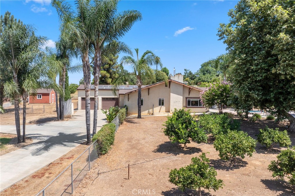 a view of a house with a tree in the background