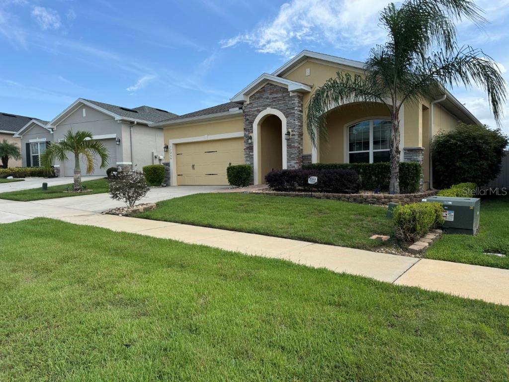 a front view of a house with a yard and garage