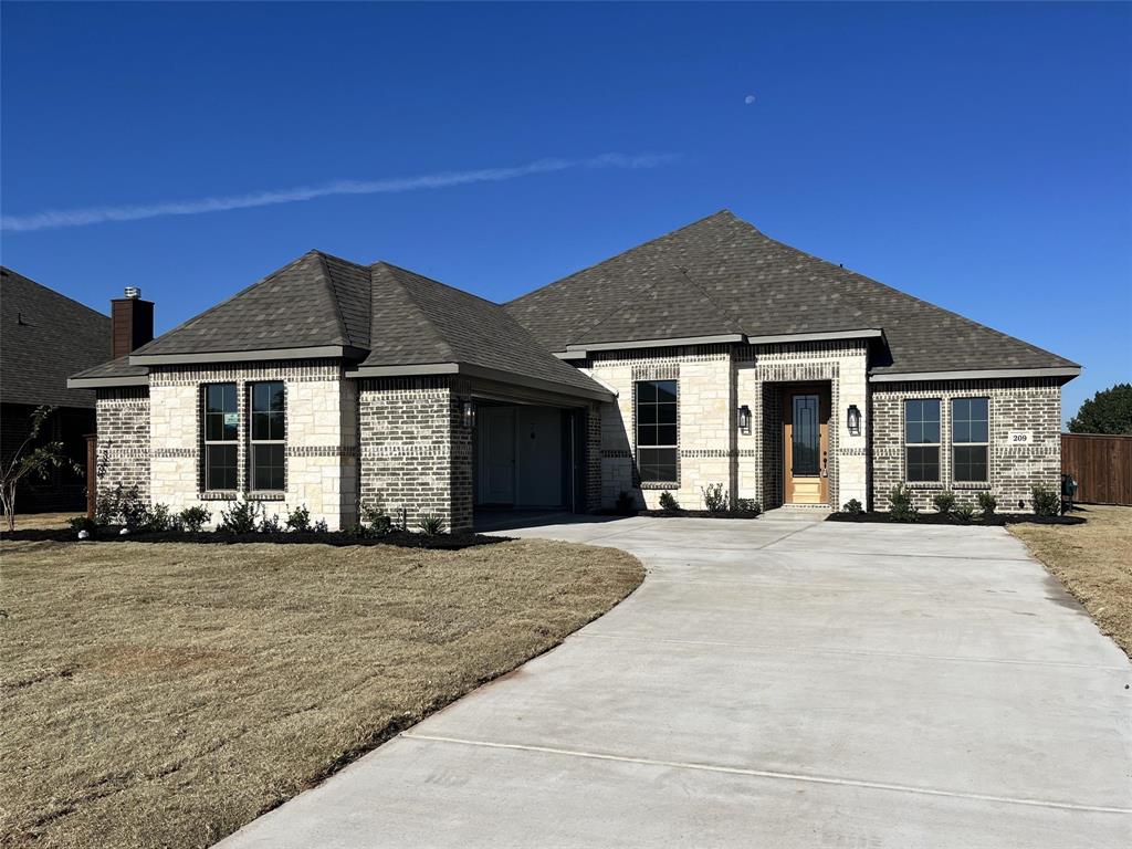 a front view of a house with a garden