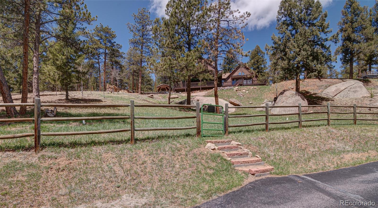 a view of backyard with wooden fence