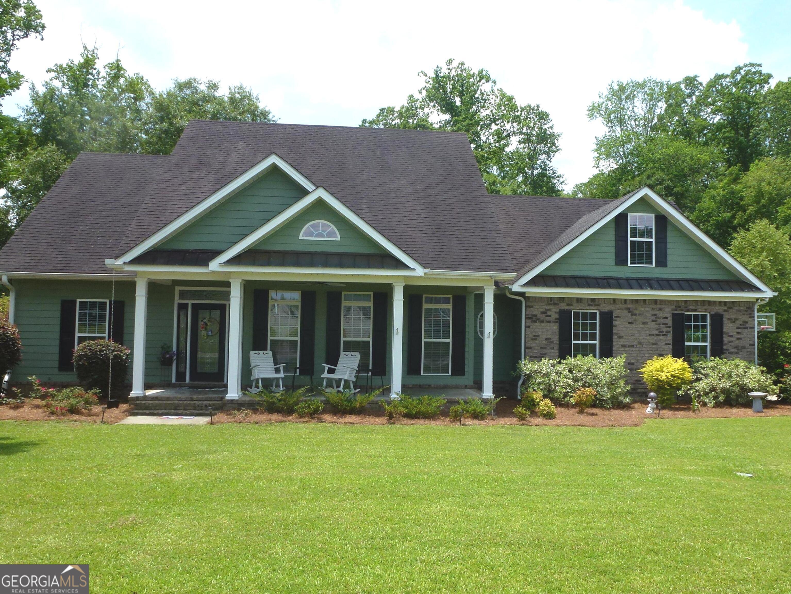 a front view of a house with garden