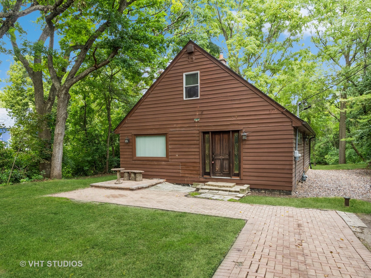 a front view of house with yard and green space