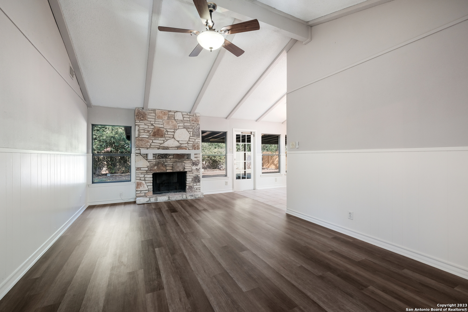 wooden floor in an empty room with a fireplace