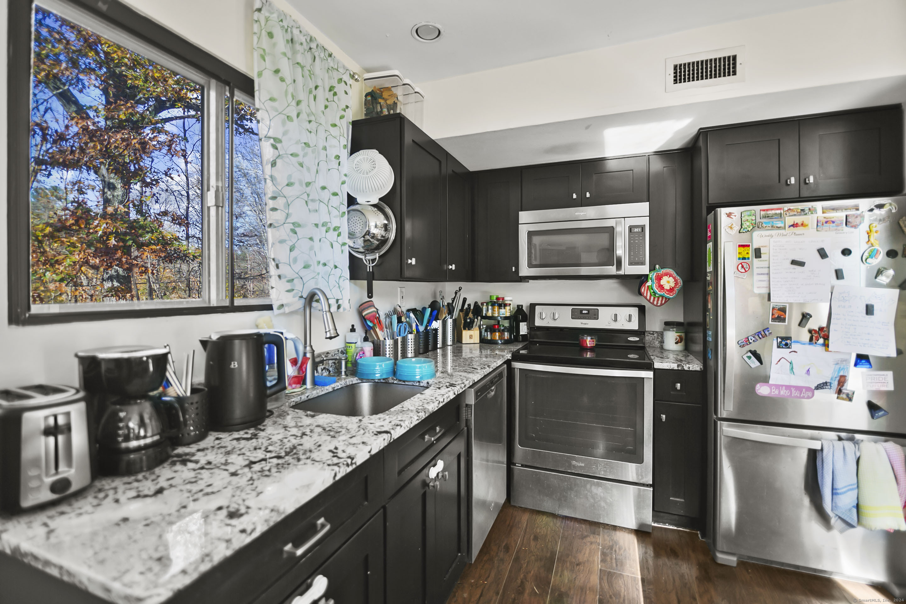 a kitchen with lots of counter top space and stainless steel appliances