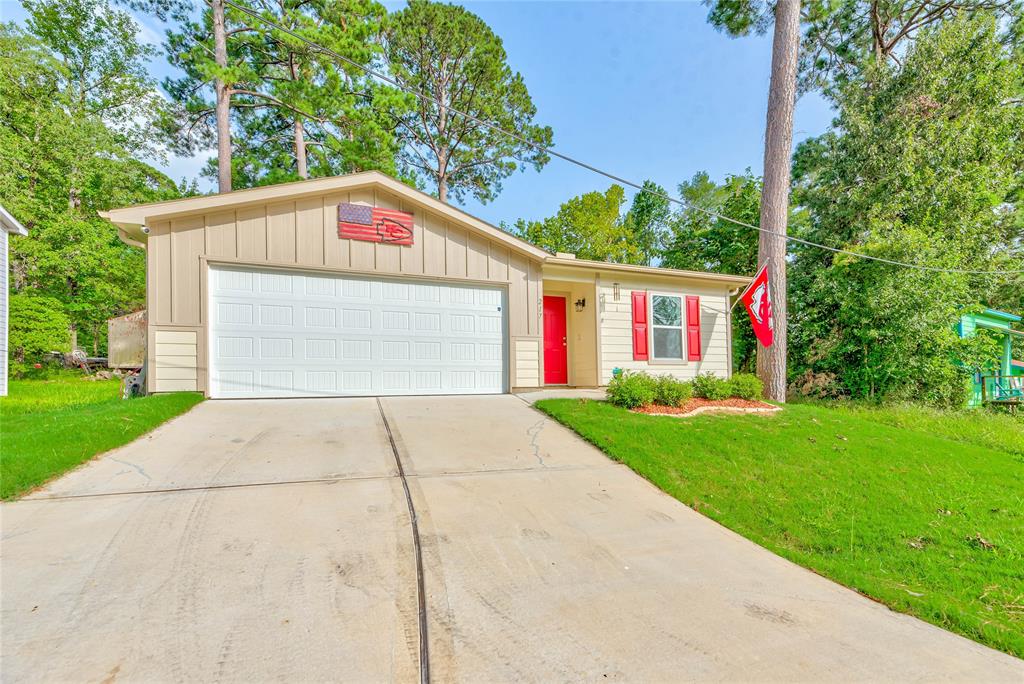 a view of a garage with a small yard