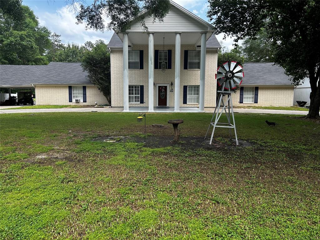 a view of a house with a backyard