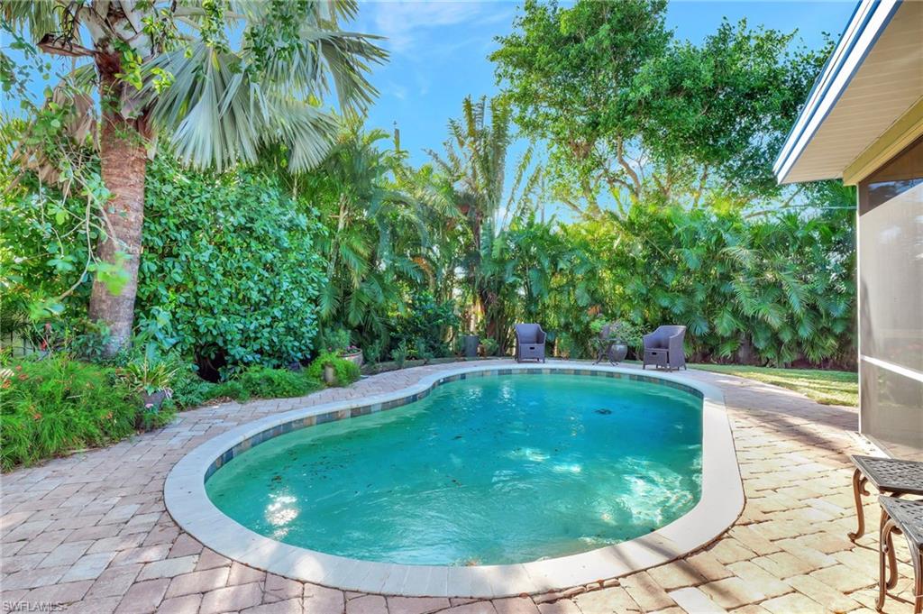 a view of a swimming pool with a yard