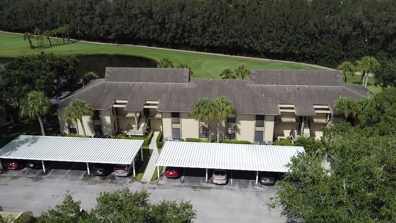 an aerial view of a house with table and chairs