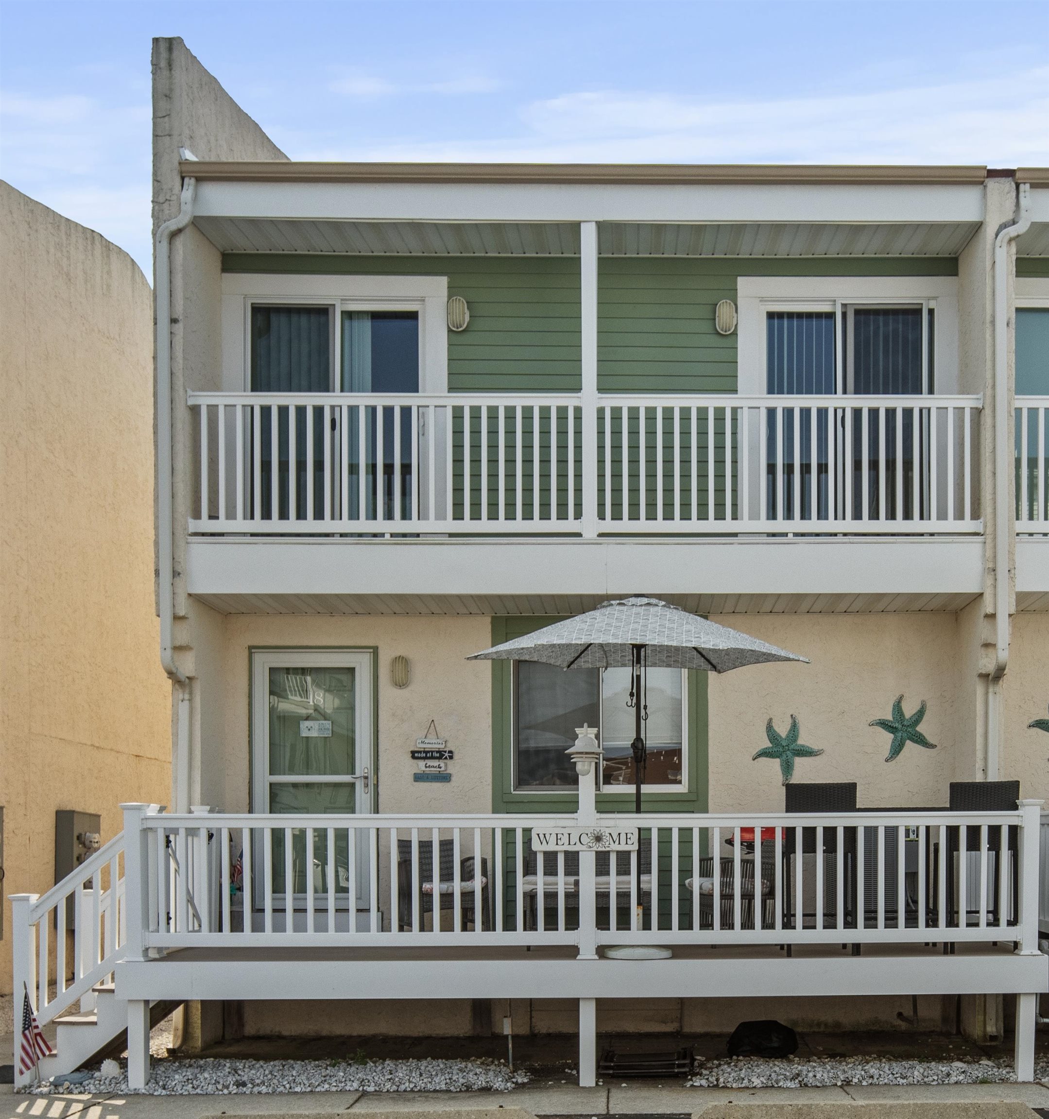 a view of a house with a deck and furniture