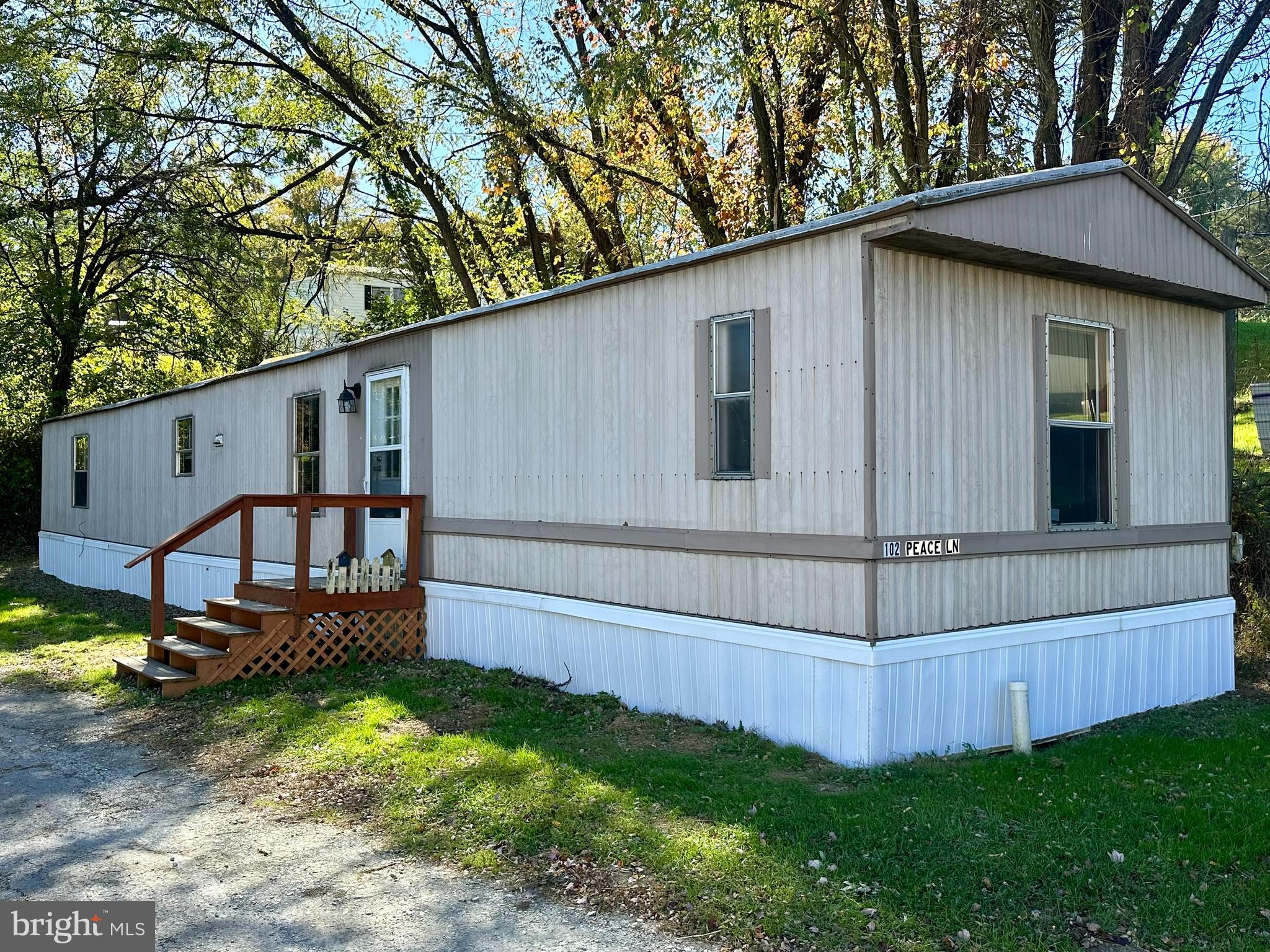 a house that has a big yard with wooden fence