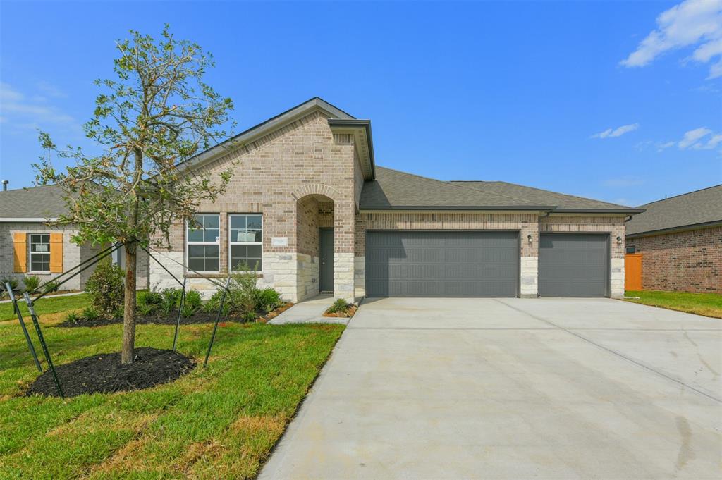 a front view of a house with a yard and entertaining space