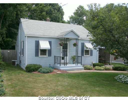 a view of a house with a yard and sitting area