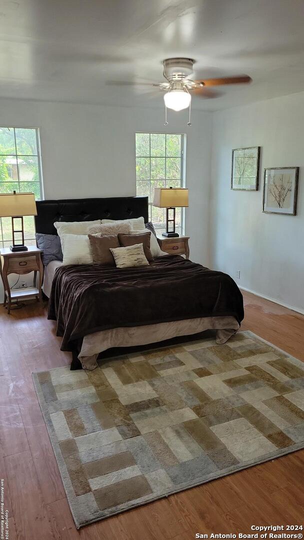 a large bed sitting in a bedroom next to a window