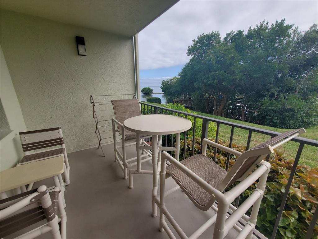 a view of a balcony with a table and chairs